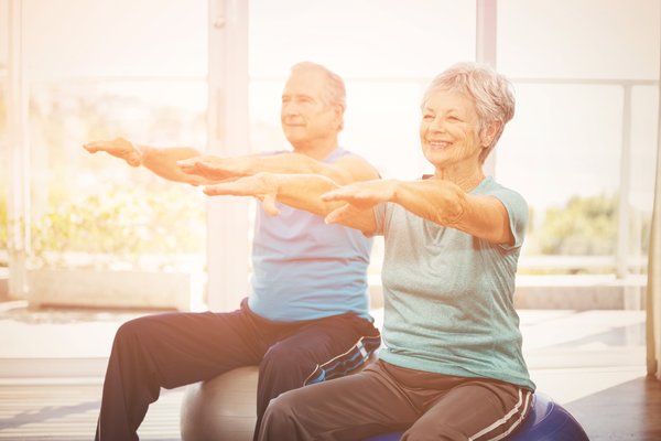 activities-senior-couple-exercising-fitness-ball